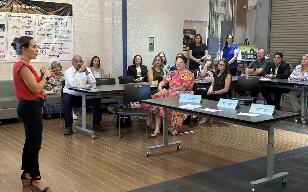 A woman talks to a room full of teachers.