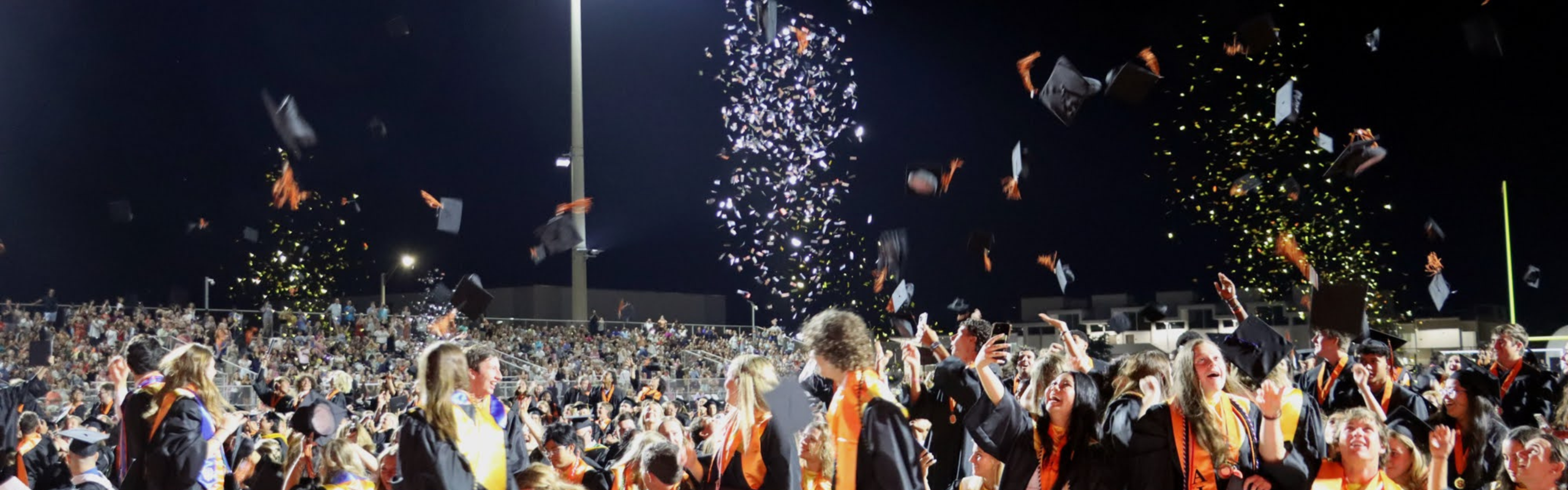 a group of people throwing confetti in the air